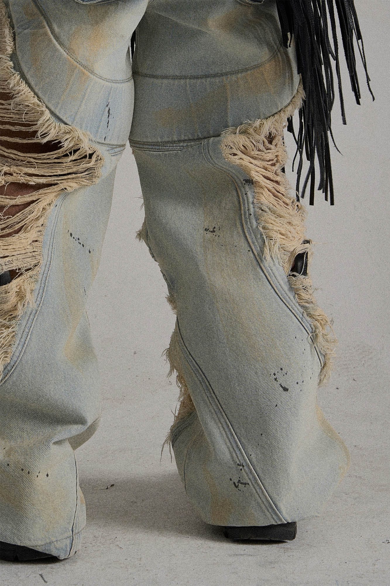 Paneled Heavily Ripped Fringe Jeans